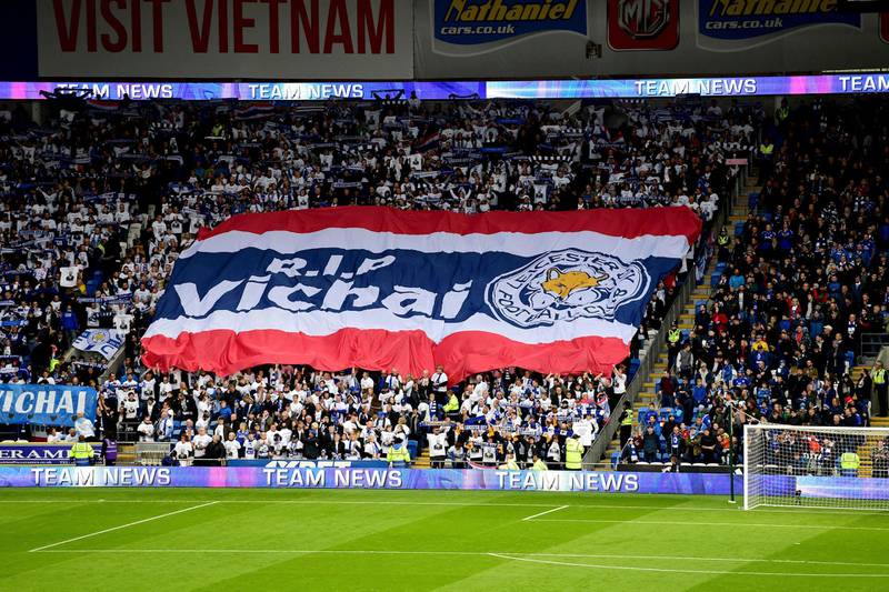 Leicester City fans with a giant banner that reads 'RIP Vichai' during the English Premier League soccer match between Cardiff City and Leicester City at the Cardiff City Stadium, Cardiff. Wales. AP