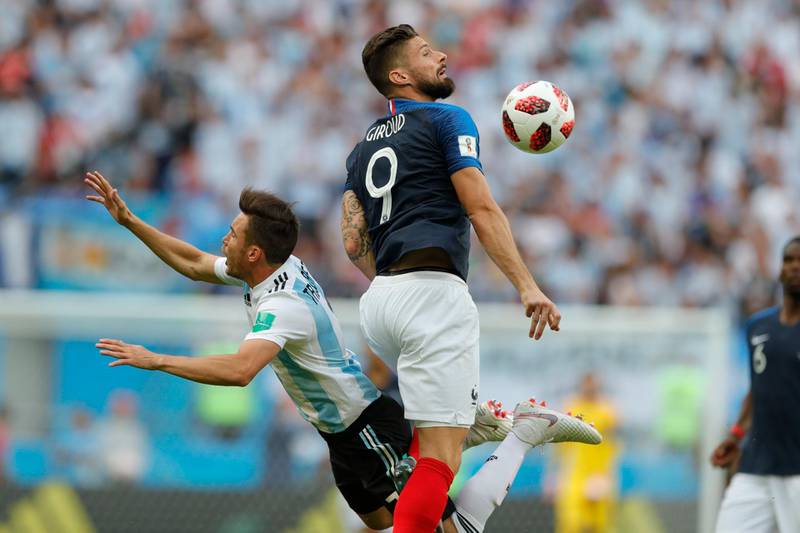 France's Olivier Giroud, right, fouls Argentina's Nicolas Tagliafico. Ricardo Mazalan/ AP Photo