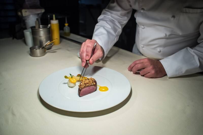 Executive Chef Yannick Franques arranges a duck dish at the restaurant La Tour d'Argent, the oldest establishment in the French capital dating from 1582, in Paris, France, 24 March 2022. EPA