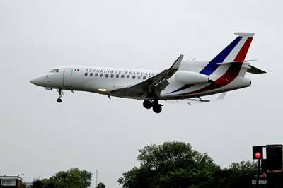 A plane carrying French president Emmanuel Macron lands at RAF Northolt for his visit to Britain. PA via AP