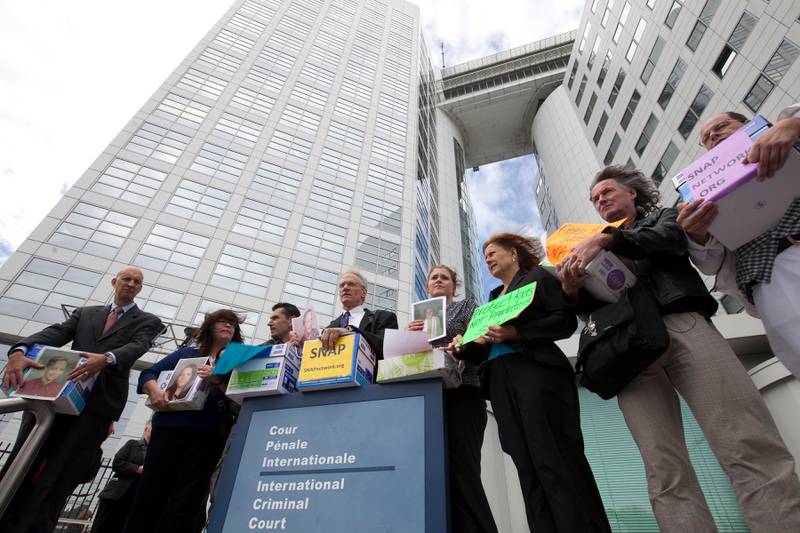 Members of Survivors Network of those Abused by Priests (SNAP), from left: Peter Isely, Rita Milla, Emmanuel Henckens, Phil Saviano, Megan Peterson, Barbara Blaine, Bert Smeets and Winfried Fesselmann pose in front of the International Criminal Court (ICC) in The Hague, Netherlands, Tuesday, Sept. 13, 2011. Clergy sex abuse victims upset that no high-ranking Roman Catholic leaders have been prosecuted for sheltering guilty priests brought their claims to the ICC, seeking an investigation of the pope and top Vatican cardinals for possible crimes against humanity. The Center for Constitutional Rights, a New York-based nonprofit legal group, requested the inquiry on behalf of the SNAP, arguing that the global church has maintained a "long-standing and pervasive system of sexual violence" despite promises to swiftly oust predators. The Vatican said it had no immediate comment. (AP Photo/Rob Keeris) *** Local Caption ***  Netherlands International Court Pope Abuse.JPEG-04b28.jpg