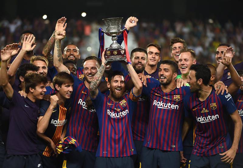Barcelona's Lionel Messi lifts the Super Cup. Reuters