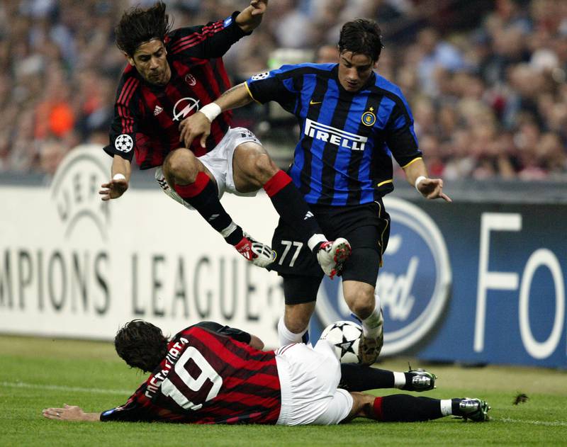 Inter Milan's Francesco Coco  is tackled by both Rui Costa and Alessandro Costacurta of AC Milan during the first leg. Getty