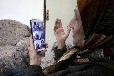 Palestinian Shahira Qafisheh, 85, video chats with her daughters during the coronavirus lockdown in the occupied West Bank city of Hebron.  AFP