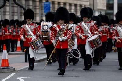 Troops in full ceremonial uniform arrive at Waterloo train station from their barracks and march across Westminster Bridge in London. Reuters