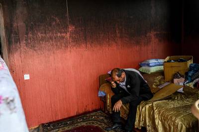Razim Mehmedov, 40, sits in a bedroom of his flat that was damaged and burnt by shelling as residents return to their homes in Terter. AFP