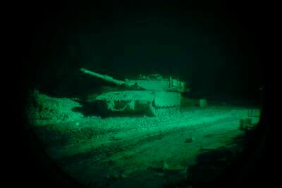An Israeli tank appears through a soldier's night vision scope near the Gaza Strip in southern Israel. Getty Images