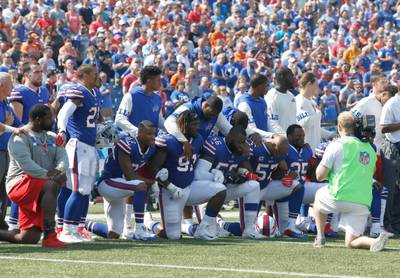 Sep 24, 2017; Orchard Park, NY, USA; Buffalo Bills players kneel in protest during the National Anthem before a game against the Denver Broncos at New Era Field. Mandatory Credit: Timothy T. Ludwig-USA TODAY Sports