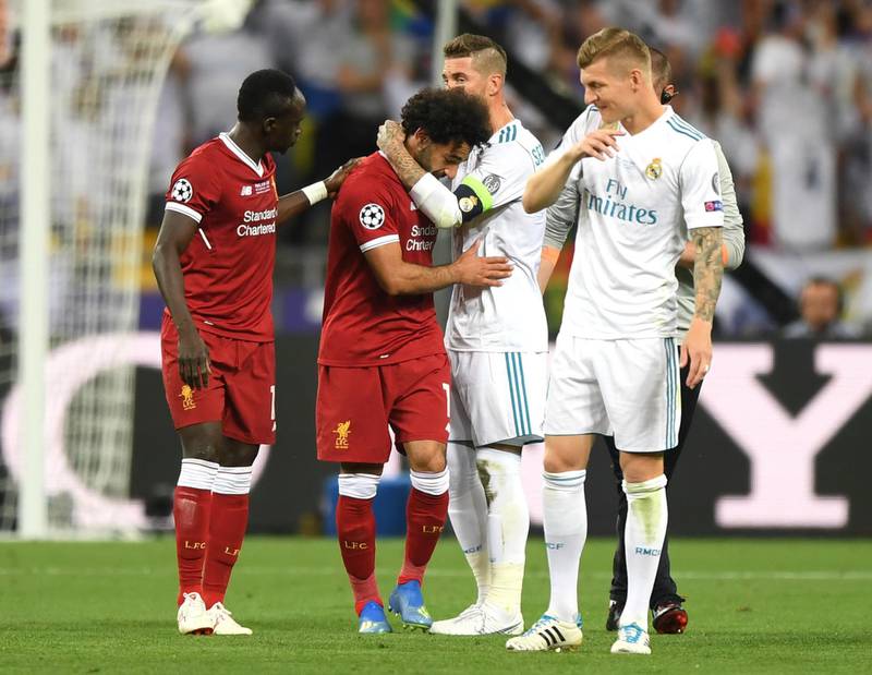 Sadio Mane of Liverpool, Sergio Ramos and Toni Kroos of Real Madrid console Mohamed Salah. Shaun Botterill / Getty Images