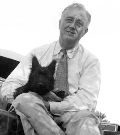 President Franklin D Roosevelt with his dog Fala at a picnic on Sunset Hill. At the time, Fala was four months old. Wiki Commons