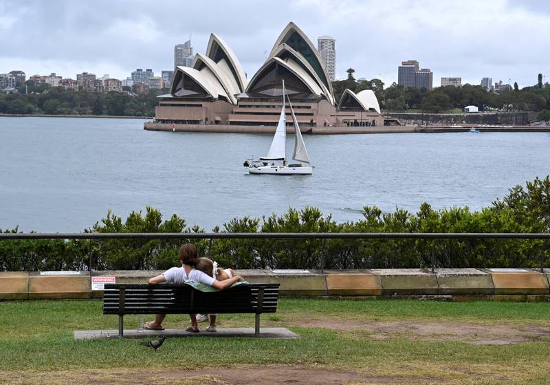 A couple sit by the harbour in Sydney, Australia. Reuters