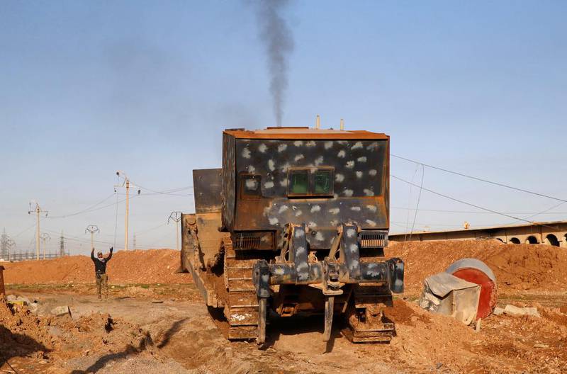 Iraqi security forces maneuver a military vehicle during clashes with Islamic State militants.