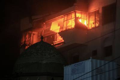 A residential building on fire following Israeli air strikes in Gaza city. Bloomberg