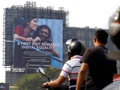 Motorists ride past a billboard displaying Facebook's Free Basics initiative in Mumbai. Danish Siddiqui / Reuters