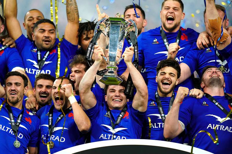 France's Antoine Dupont, centre, lifts the trophy with teammates after winning the Six Nations at the Stade de France, Paris. PA