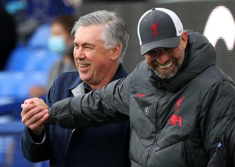 Liverpool manager Juergen Klopp and his Everton counterpart Carlo Ancelotti share a joke at Goodison Park. Reuters