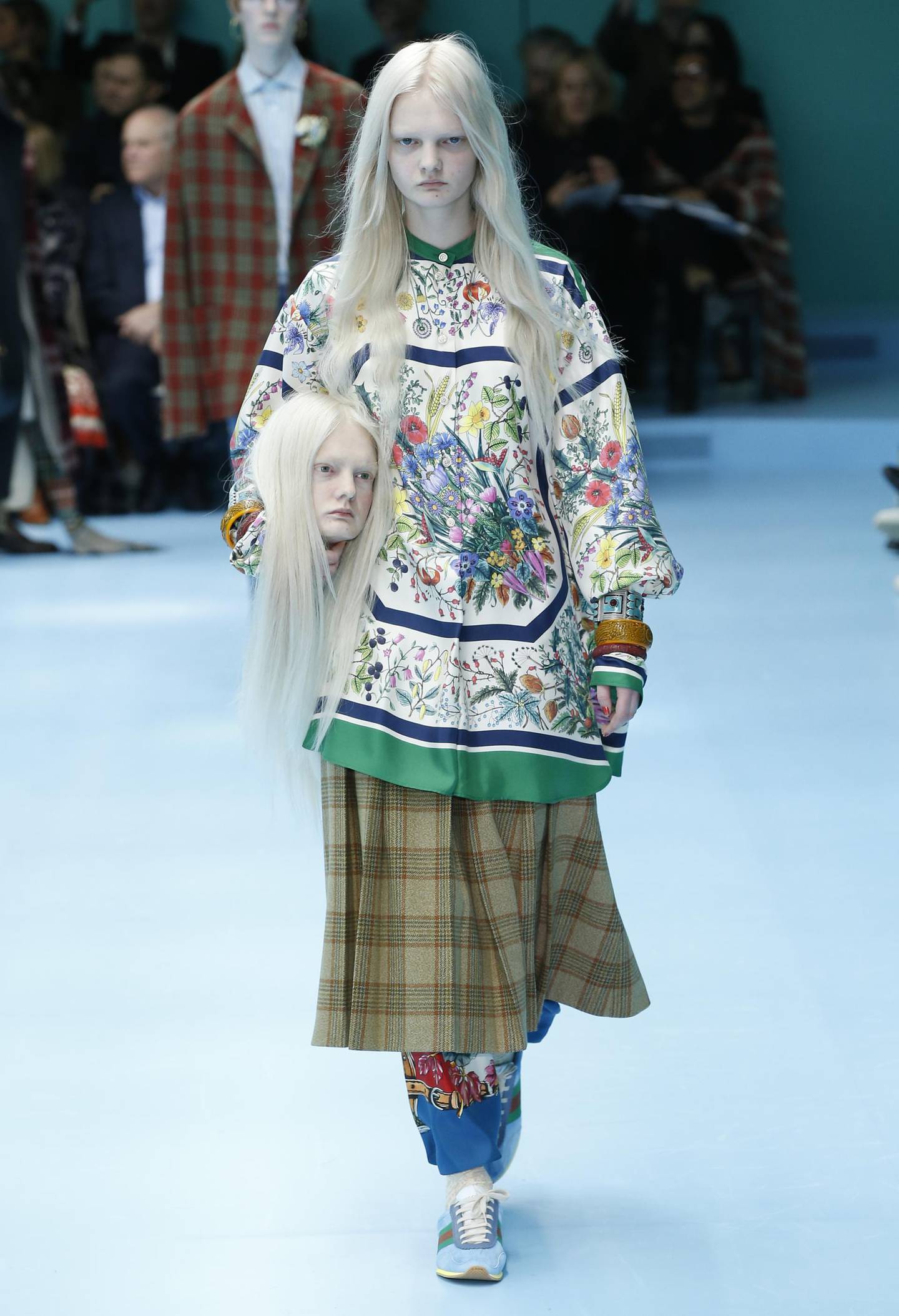 Models carry their own heads at Gucci Autumn Winter 2018 womens collection at Milan Fashion Week
