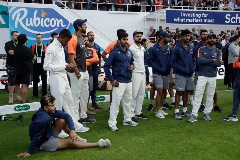 India captain Virat Kohli, center, and the India team wait for the trophy presentations to start after England won the fifth cricket test match and the five match series between England and India at the Oval cricket ground in London, Tuesday, Sept. 11, 2018. (AP Photo/Matt Dunham)