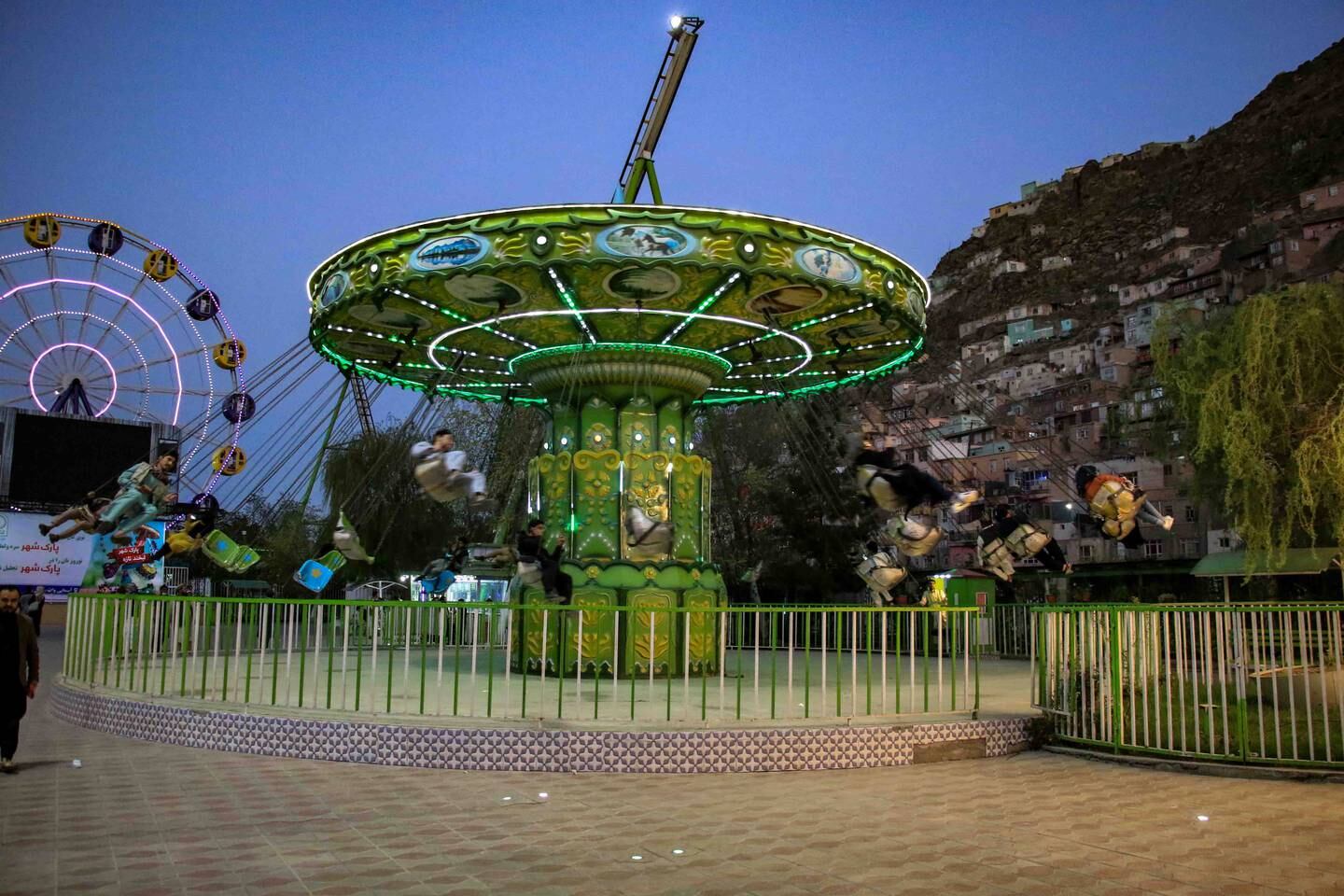 A few Afghan men visit an amusement park in Kabul after the morality ministry said that women will be restricted from entering public parks.  EPA