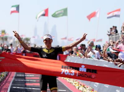 Anne Haug of Germany celebrates winning the women's race Ironman 70.3 Dubai. Nigel Roddis / Getty Image