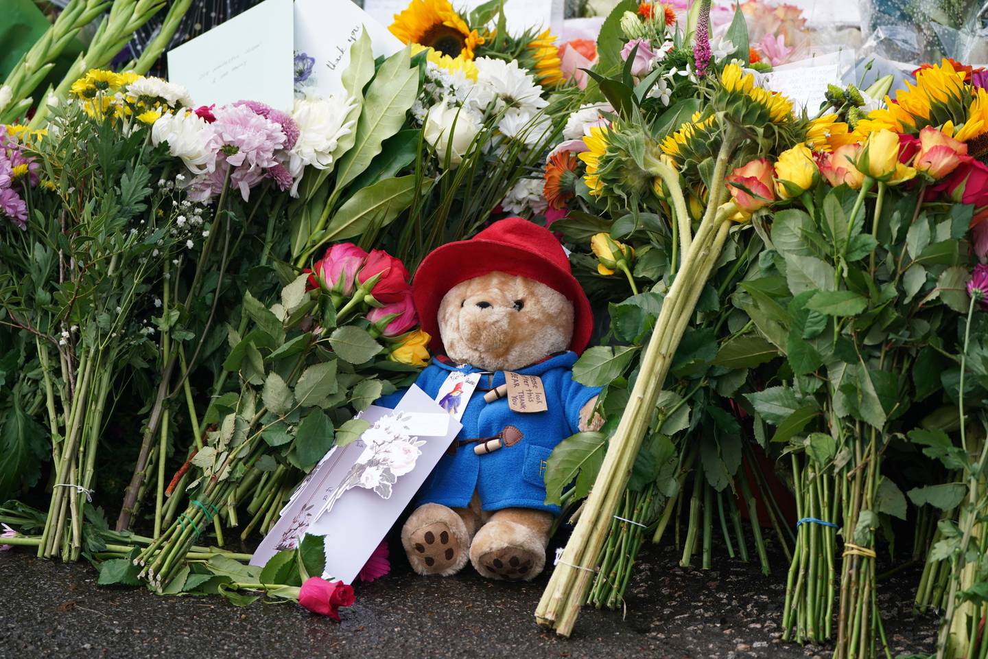 Floral tributes and a Paddington teddy bear at the gates of Balmoral in Scotland after the death of Queen Elizabeth. PA