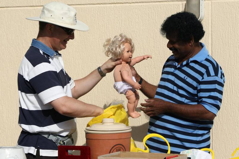 DUBAI, UNITED ARAB EMIRATES - MAY 1:  Rob Ovens (L) makes a sale to Nimal Jayalath (R) at a garage sale in the Umm Suqueim district of Dubai on May 1, 2009. Rob and his wife Alison (not pictured) are from the UK and have been living in Dubai for the past three years. They are now in the process of moving back to England due to RobÕs redundancy with his employer.  (Randi Sokoloff / The National)  For News story by Leah Oatway *** Local Caption ***  RS017-050109-SALE.jpgna02ma-sale3.jpg