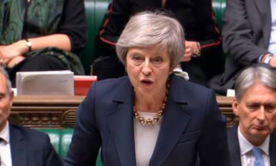 Britain's Prime Minister Theresa May speaks in parliament at the start of a five-day debate on the Brexit European Union Withdrawal Agreement, Tuesday Dec. 4, 2018. The British government received a historic rebuke from lawmakers on Tuesday over its Brexit plans, an inauspicious sign for Prime Minister Theresa May as she opened an epic debate in Parliament that will decide the fate of her Brexit divorce deal with the European Union.(Parliament TV/PA via AP)