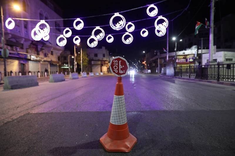 A stop sign is displayed at a checkpoint where Jordanian police stand guard during curfew in Amman, Jordan. Reuters