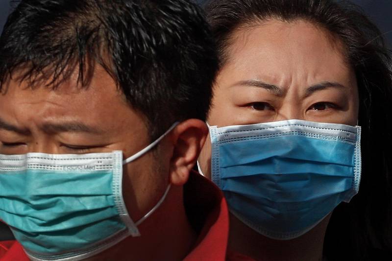 People wearing face masks to help curb the spread of the coronavirus ride a scooter on a street in Beijing, China, on Thursday, May 6, 2021. AP Photo