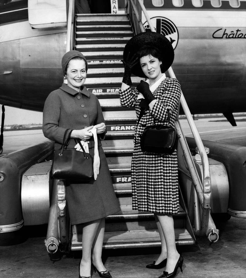 US actress Olivia de Havilland, left, and Lollobrigida  at a Parisian airport in 1963. AFP