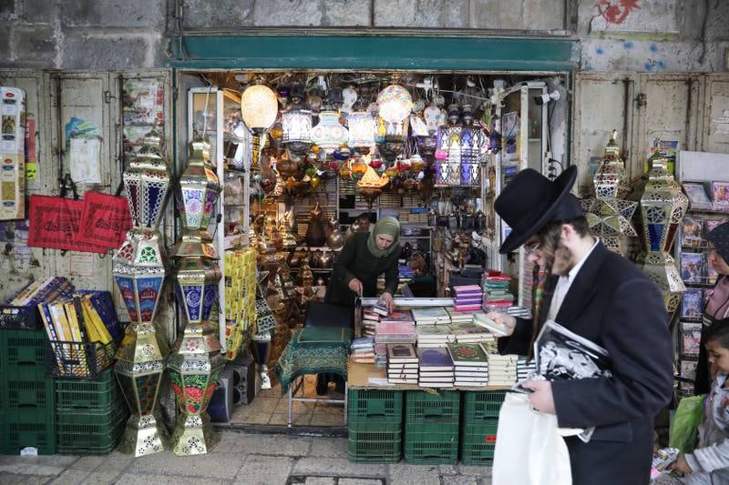 An Orthodox Jewish man walks past a shop selling Ramadan fanous lanterns near one of the entrances to Al Aqsa Mosque. EP