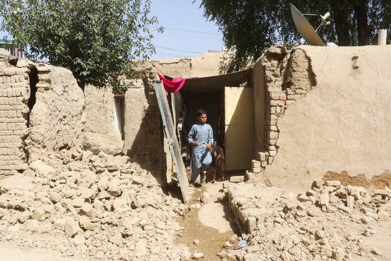 A boy leaves his damaged family house, following an earthquake, in the mountainous Harnai district in south-west Pakistan. Reuters