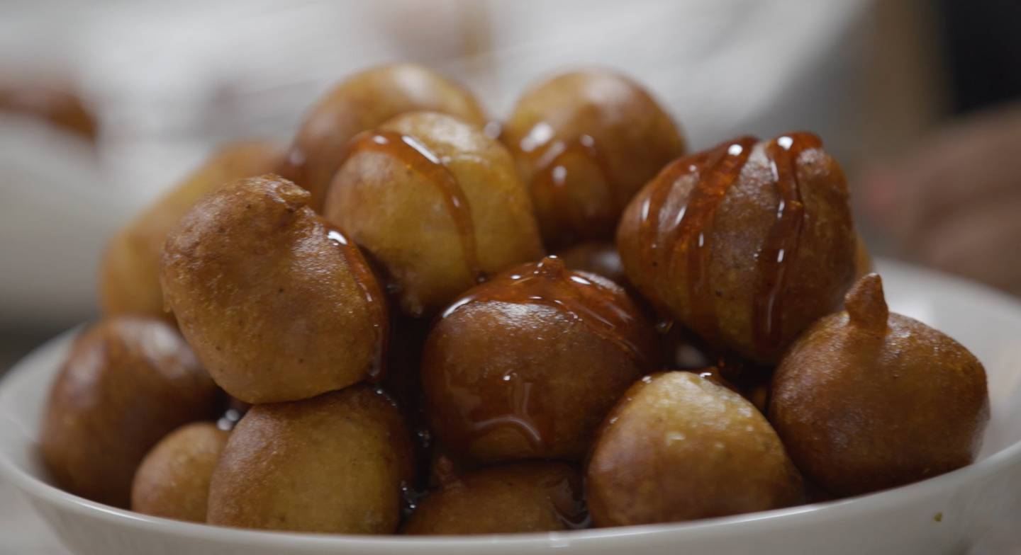 Khulood Atiq's luqaimat, which is a popular Middle Eastern dessert prepared with yeast-leavened dough, which is deep fried and drizzled with date syrup.