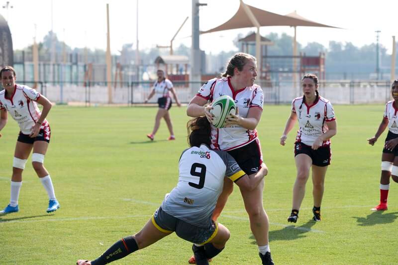 Amy Shelford, from Abu Dhabi Bats, makes a tackle.