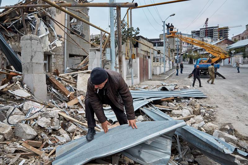 A man rummages through the remains of a home that was damaged by Azeri artillery in Stepanakert, Nagorno-Karabakh. Getty