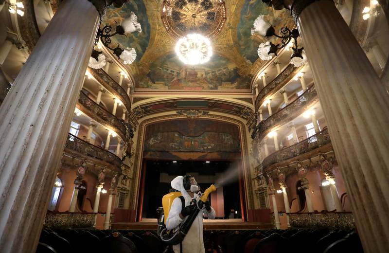 A worker in a protective suit sprays to disinfect the Amazonas Theatre ahead of its reopening in Manaus, Brazil. Reuters