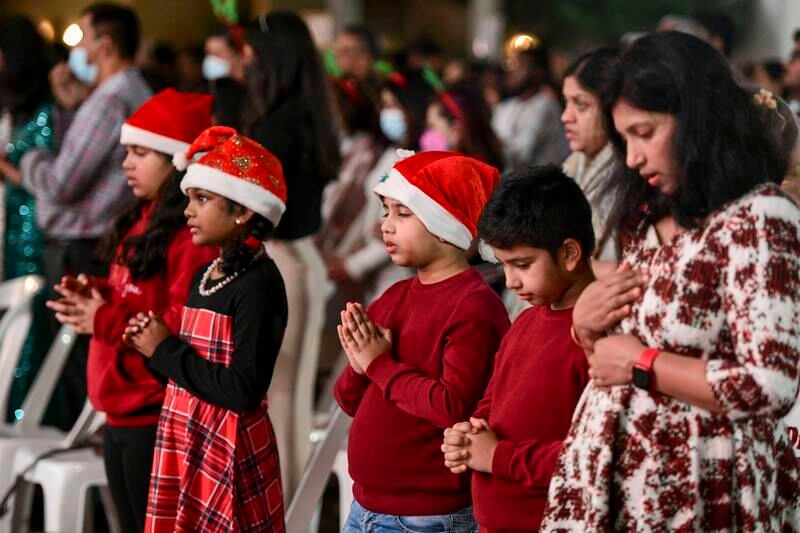 Worshippers gather for Christmas Eve midnight mass at St Joseph's Cathedral, Abu Dhabi. Khushnum Bhandari / The National

