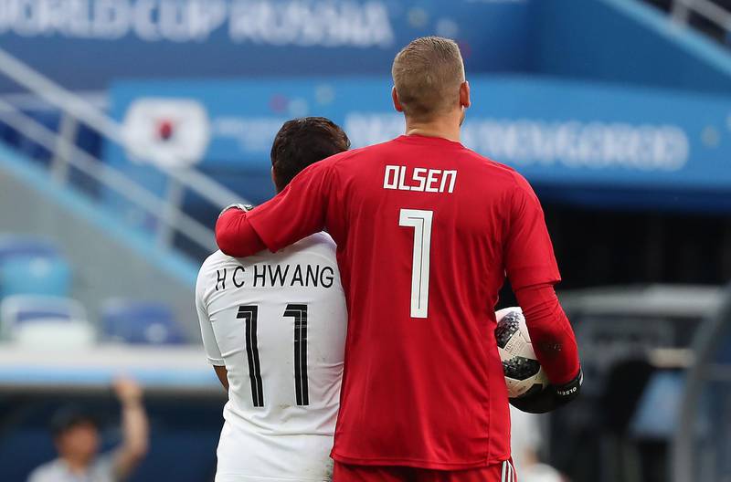 Hwang Hee-chan of South Korea, left, and goalkeeper Robin Olsen of Sweden. Vassil Donev / EPA