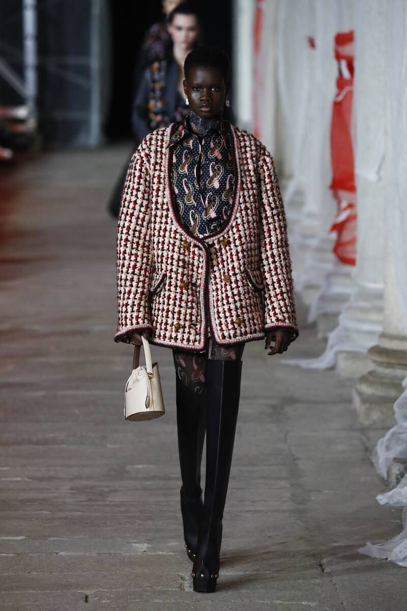 Exaggerated checked coats with floral dresses and matte rubber boots at Etro. Getty Images 