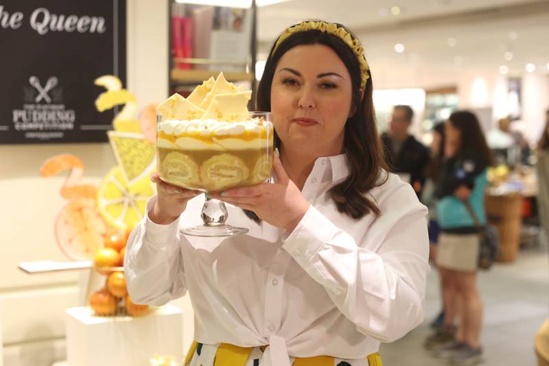 Jemma Melvin poses in Fortnum and Mason, central London, with her lemon Swiss roll trifle that beat 5,000 desserts to become the official pudding of the jubilee celebrations. PA