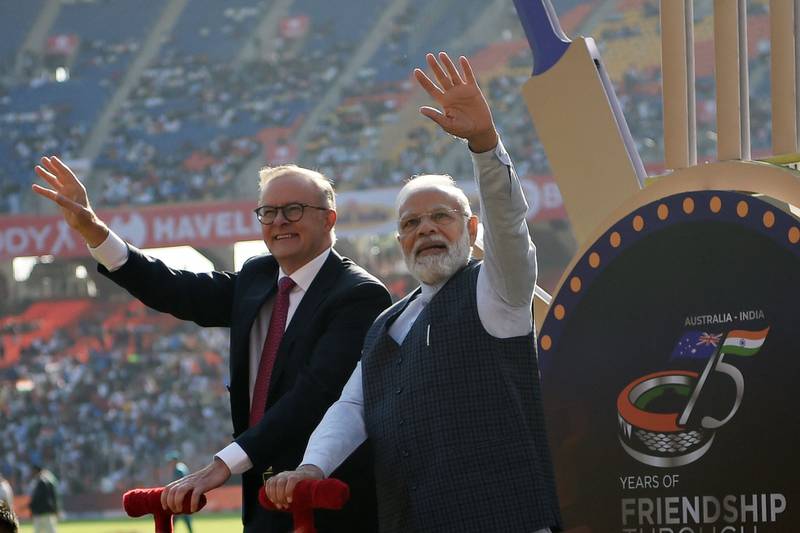 Indian Prime Minister Narendra Modi and Australia's Prime Minister Anthony Albanese wave to spectators at the Narendra Modi stadium in Ahmedabad. AFP