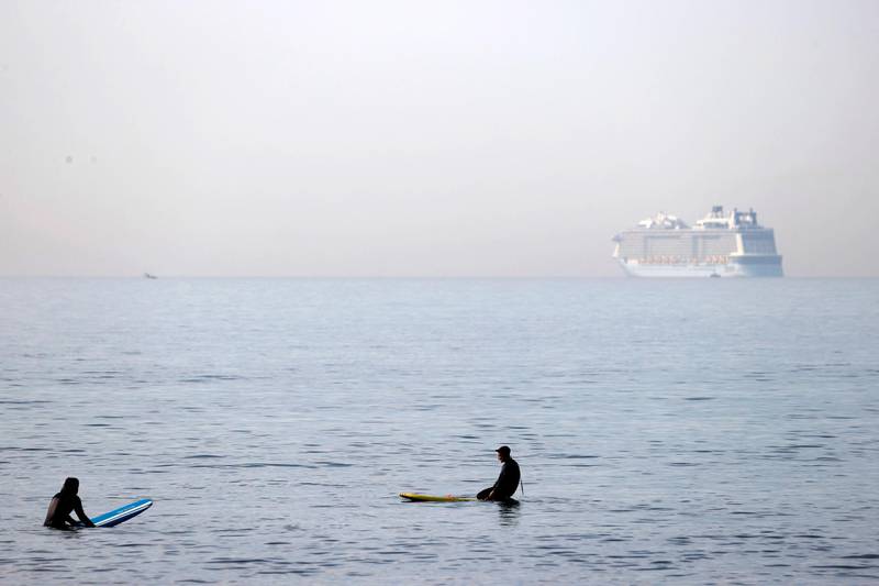 Paddleboarders take a rest as they sit on the boards in the sea in Bournemouth. AFP
