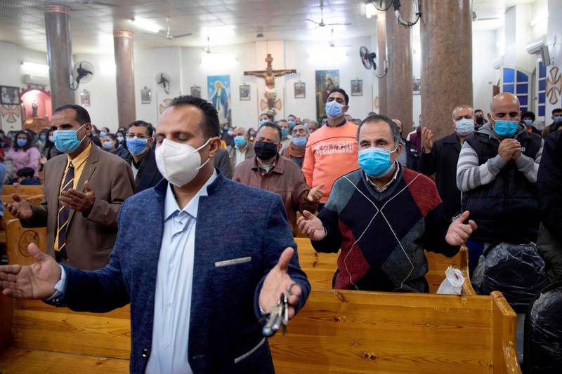 Egyptian Christians worshippers attend Christmas Eve mass at the Coptic Catholic St. Mark Church in Minya city. AFP