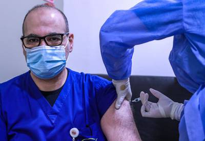Abu Dhabi, United Arab Emirates, December 13, 2020.   Doctors and UAE residents get Covid-19 vaccinated at the Burjeel Hospital, Al Najdah Street, Abu Dhabi.  Dr. Ayman Mohamed Abdelhady gets vaccinated.Victor Besa/The NationalSection:  NA