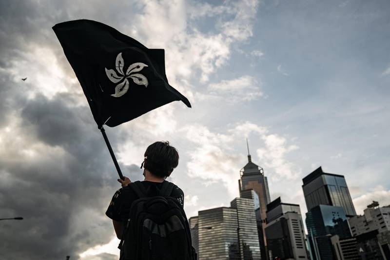An anti-extradition protester waves a black flag on a street outside the Legislative Council Complex. Getty Images