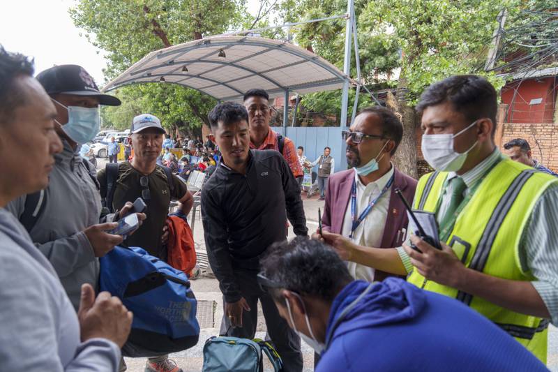 Climbers prepare to leave for rescue operations from Tribhuvan International Airport. Rescue teams later located the wreckage of the Tara Air aircraft in a remote location. AP