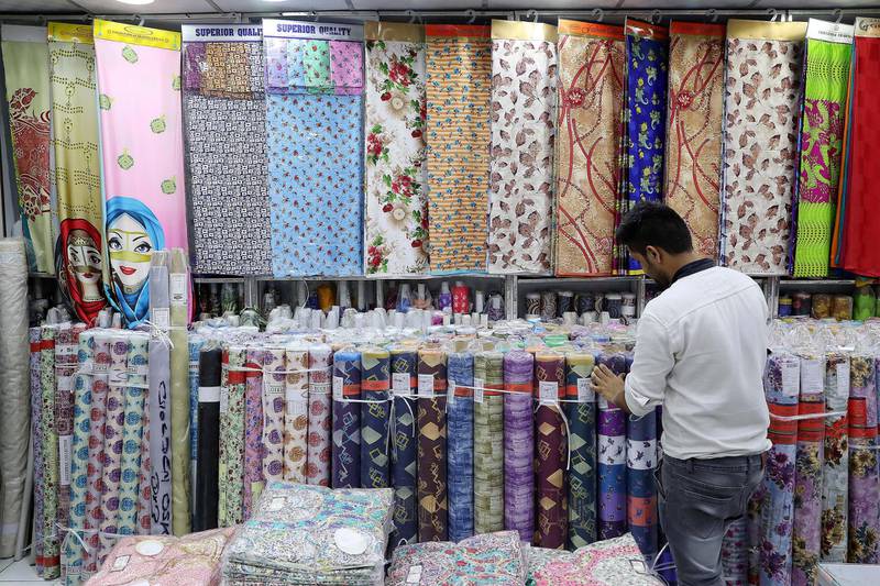 DUBAI , UNITED ARAB EMIRATES , JULY 25 – 2018 :- Inside view of the Golden Oskar garment and textile shop in Meena Bazaar in Dubai.  ( Pawan Singh / The National )  For News. Story by Ramola