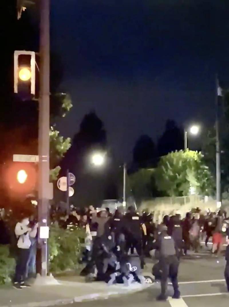 Police detain a protester during a demonstration in Portland, U.S. in this still image taken from a video obtained from social media. TWITTER/Reuters