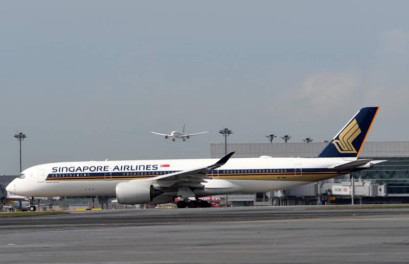 Singapore Airlines (SIA) welcomes the world's first Boeing 787-10 aircraft (in the air) as it approaches after its flight from Boeing's production facility in North Charleston, South Carolina at Singapore Changi Airport on March 28, 2018. - The 787-10 is the latest variant of Boeing's Dreamliner family of aircraft. SIA is the largest customer for the 787-10, with firm orders for 49 of the type. (Photo by Roslan RAHMAN / AFP)