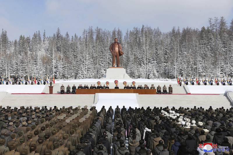 North Korean leader Kim Jong Un (C) attending a national meeting to celebrate the 80th anniversary of the birth of chairman Kim Jong Il, in front of his statue in Samjiyon City, North Korea. AFP